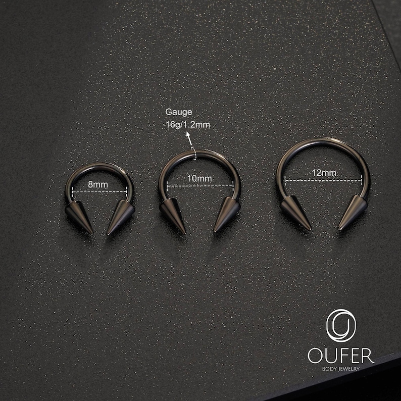 May include: Three black circular barbells with spike ends, featuring a 16g/1.2mm gauge. The rings have internal diameters of 8mm, 10mm, and 12mm respectively. The OUFER BODY JEWELRY logo is visible in the bottom right corner of the image.