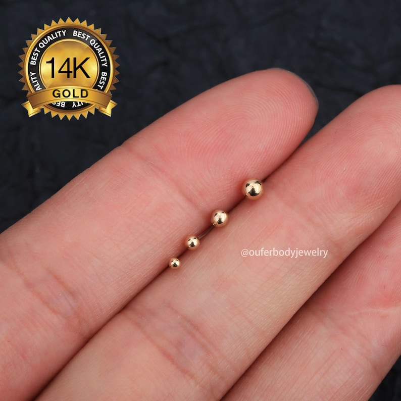 May include: Four gold ball end studs in different sizes. The balls are smooth and shiny. The studs are made of 14k gold.