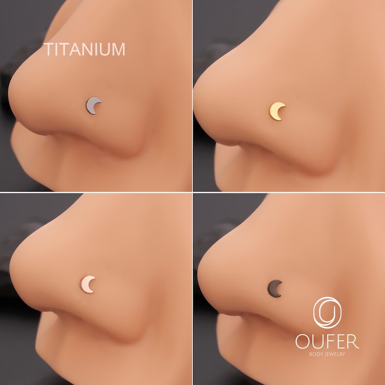 May include: Nose studs with a crescent moon design in silver, gold, and black. The word "TITANIUM" is visible. The brand "OUFER BODY JEWELRY" is displayed. The image showcases body jewellery, with a focus on the moon-shaped studs.