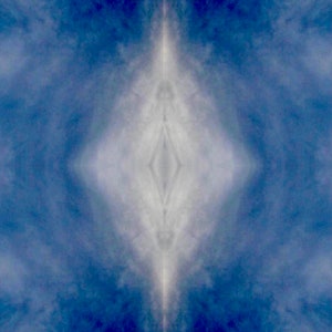 May include: A symmetrical abstract image of a white diamond shape in the centre of a blue background. The diamond shape is surrounded by a hazy white cloud-like pattern.