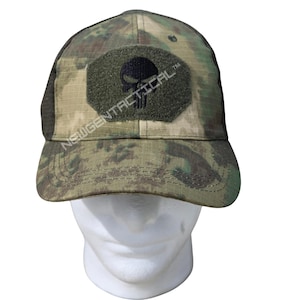 May include: A camouflage baseball cap featuring a dark green hexagonal patch on the front panel. The patch displays a black skull graphic and the text NEWGENTACTICAL. The cap has a curved brim and a structured crown with a mesh back panel.