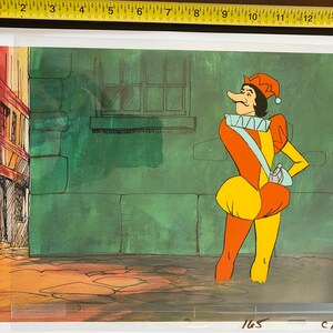 May include: A cartoon illustration of a jester in a colorful outfit. The jester wears a red and yellow hat, an orange and yellow tunic, and a blue sash. The background features a green wall and a building.