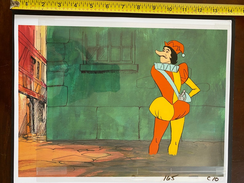 May include: A cartoon illustration of a jester in a colorful outfit. The jester wears a red and yellow hat, an orange and yellow tunic, and a blue sash. The background features a green wall and a building.