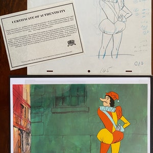 May include: An original production cel from the Hanna-Barbera animated version of Cyrano de Bergerac. The image features a colorful cartoon character with a long nose, wearing a red and yellow outfit. Includes a certificate of authenticity.