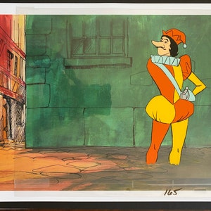 May include: Animation cel of a cartoon jester in a colorful costume. The jester wears a red and yellow hat, a white ruffled collar, and a long nose. The background depicts a green wall and a building with a red roof.