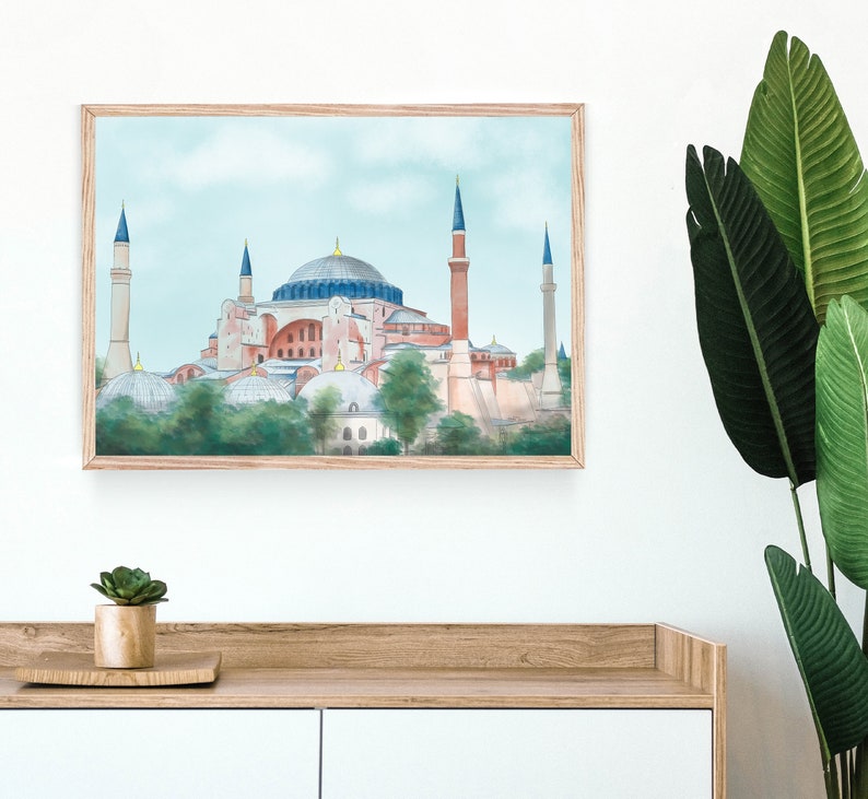 Puede incluir: Una pintura al agua enmarcada de la mezquita de Santa Sof&iacute;a en Estambul, Turqu&iacute;a. La mezquita est&aacute; pintada en tonos de rosa, rojo y azul con un cielo azul claro en el fondo.