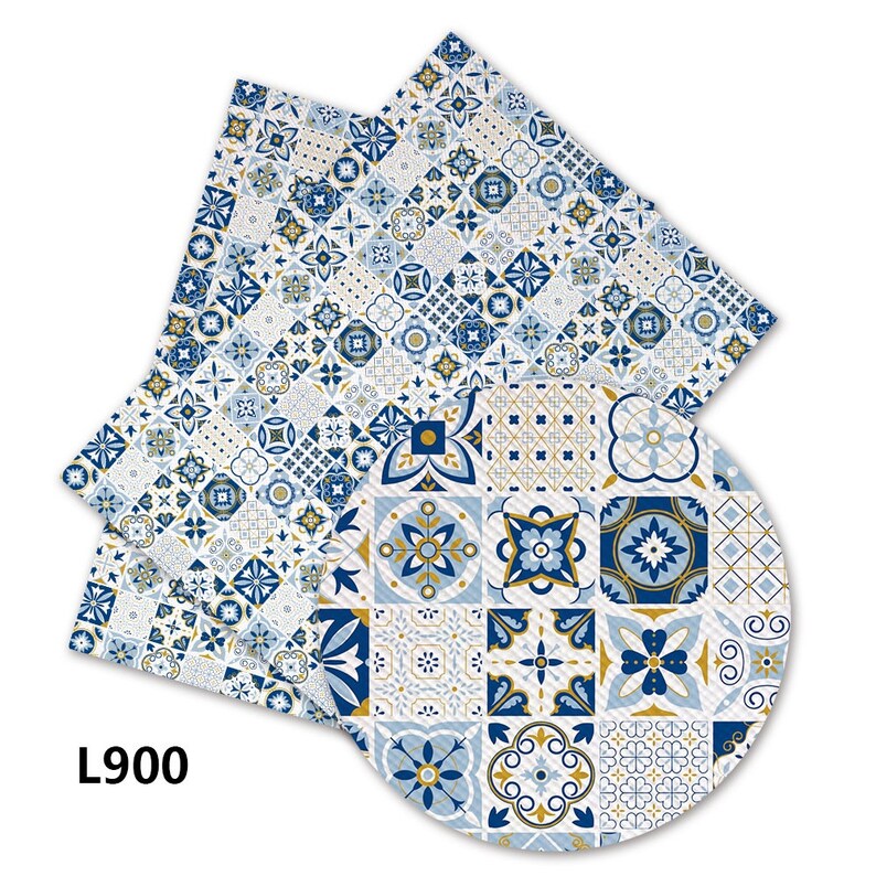 May include: Two blue and gold patterned fabric placemats with a geometric design. The placemats are made of a textured fabric and have a white background.