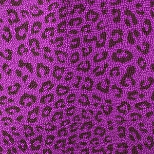 May include: Purple fabric with a leopard print pattern. The fabric has a textured surface.