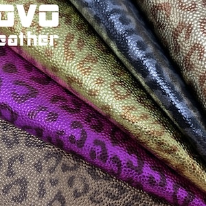 May include: Four different colours of faux leather fabric with a leopard print pattern. The colours are gold, purple, black, and brown.