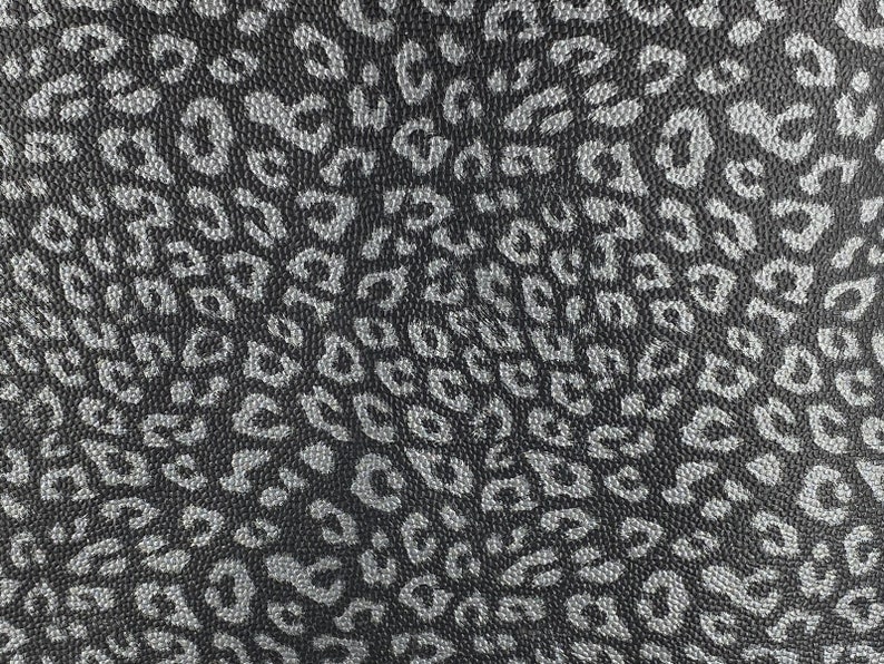 May include: Black fabric with a silver leopard print pattern.