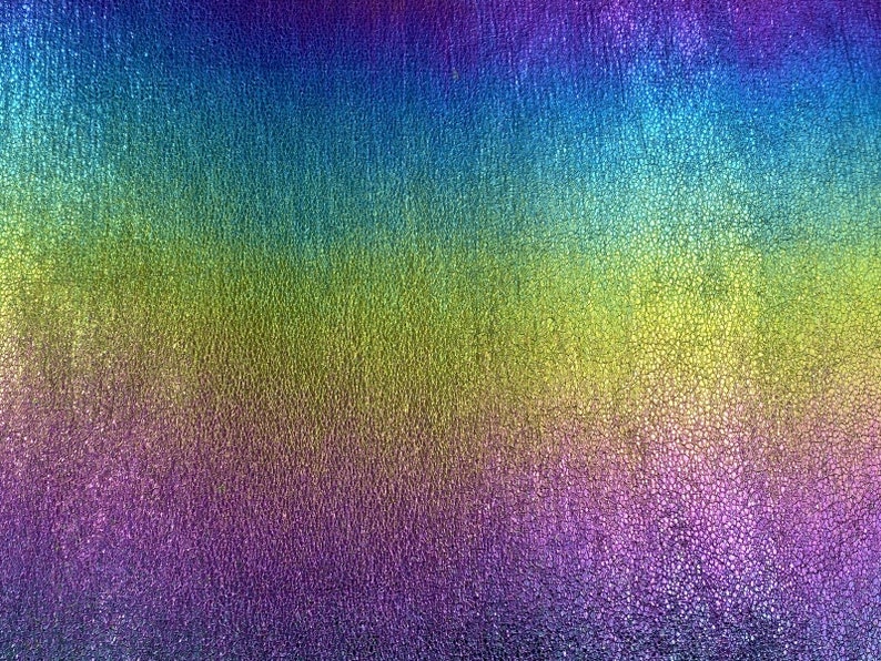 May include: A textured iridescent fabric with a gradient of colors, starting with a deep purple at the bottom, transitioning to a light green in the middle, and ending with a bright blue at the top.