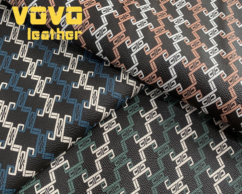 May include: Close-up of black faux leather fabric with a geometric pattern in shades of blue, green, and pink. The fabric has a textured surface and the text "VOVO leather" is visible in the top left corner.