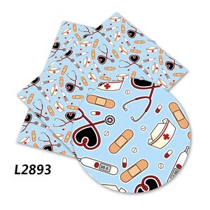 May include: A blue and white patterned fabric with a repeating design of medical symbols, including a stethoscope, bandages, pills, and nurse hats. The fabric is perfect for crafting projects, such as making tote bags, headbands, or scrunchies.