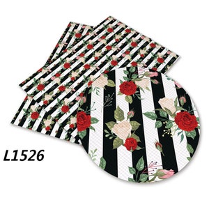 May include: Black and white striped fabric with red and white roses. The fabric is shown in two pieces, one folded over the other. The fabric has a subtle texture. The text "L1526" is visible in the bottom left corner of the image.