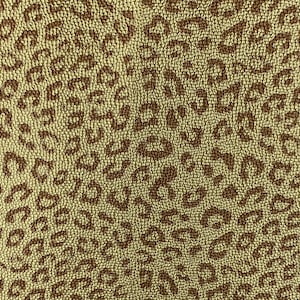 May include: A brown and beige fabric with a leopard print pattern. The fabric has a textured surface.