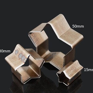 May include: Three metal star-shaped cookie cutters in different sizes: 1.5 inches, 3 inches, and 5 inches.