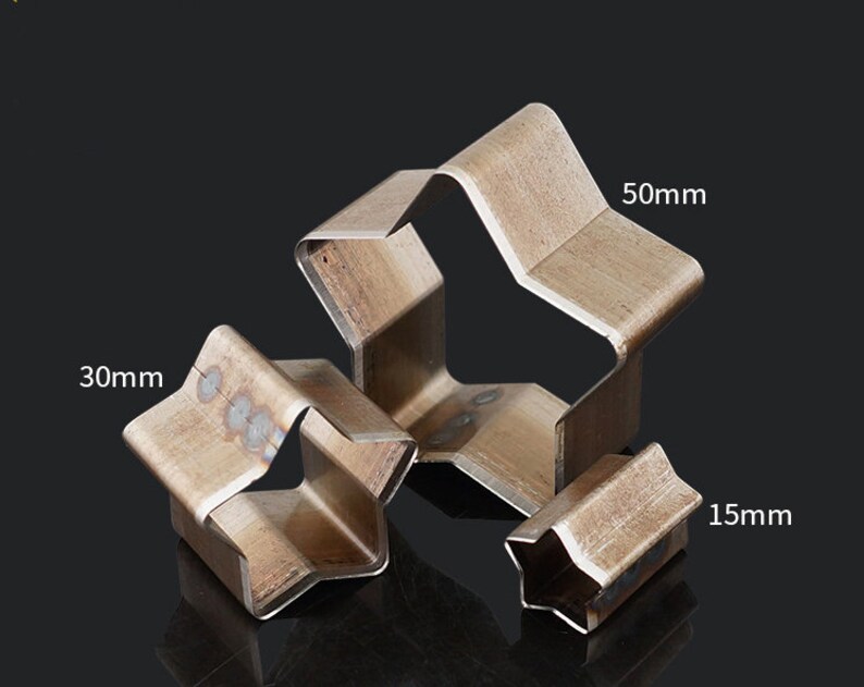 May include: Three metal star-shaped cookie cutters in different sizes: 1.5 inches, 3 inches, and 5 inches.