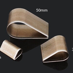 May include: Three metal craft punches in the shape of a teardrop. The largest punch is 50mm, the middle punch is 30mm, and the smallest punch is 15mm.