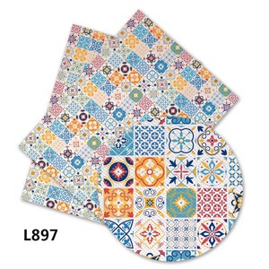 May include: A set of three colorful patterned fabric napkins with a geometric design featuring blue, yellow, red, and white tiles. The napkins are made of a soft, absorbent material and are perfect for everyday use.