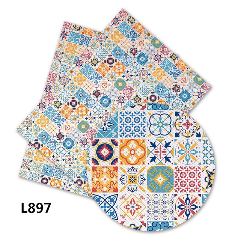 May include: A set of three colorful patterned fabric napkins with a geometric design featuring blue, yellow, red, and white tiles. The napkins are made of a soft, absorbent material and are perfect for everyday use.