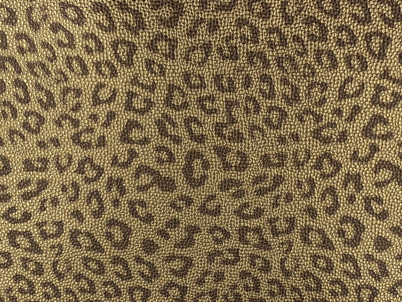 May include: Gold fabric with a brown leopard print pattern.