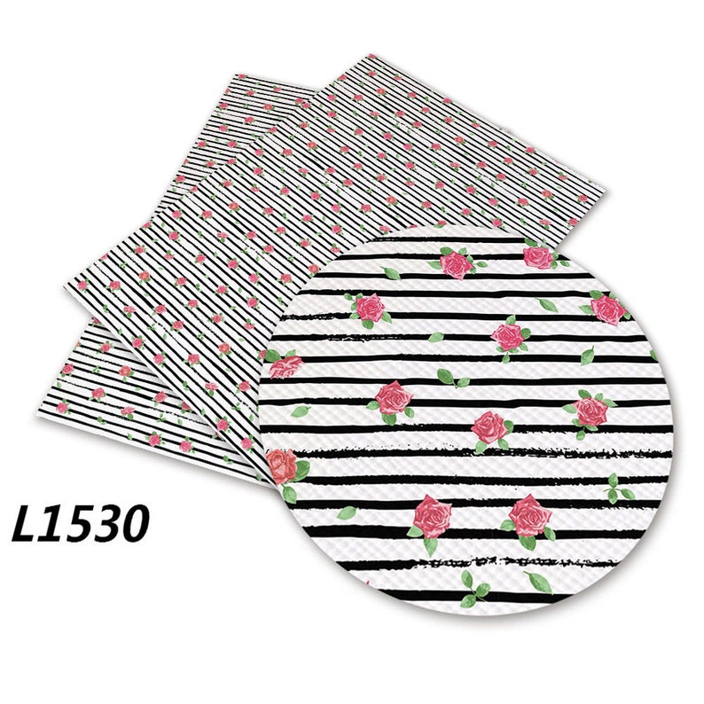 May include: Three sheets of black and white striped fabric with a pink rose pattern. The fabric has a textured surface. The fabric is labelled L1530.
