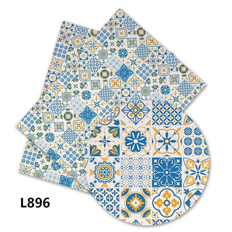 May include: A set of two blue and yellow patterned napkins with a geometric design. The napkins are made of fabric and have a white background. The text "L896" is printed on the bottom left corner of the image.
