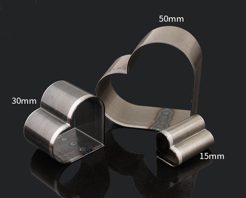 May include: Three metal heart-shaped cookie cutters. The largest cutter is 50mm wide, the middle cutter is 30mm wide, and the smallest cutter is 15mm wide.