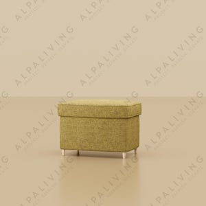 May include: A modern interior scene featuring a gold floor lamp with a dark shade and a small, square ottoman. The ottoman is upholstered in a textured, light green fabric and has silver legs. The background is a neutral beige.