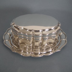 An antique biscuit box on a tray, outlined model.