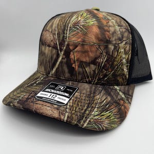 Boné de malha com fecho de pressão Any State Snow Camo ou Mossy Oak Country DNA Coyote Hunter MossyOak Country DNA