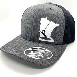 May include: A gray and black mesh trucker hat with a white outline of the state of Minnesota and a fishing lure. The hat has a Flexfit Tech label with the text "110 One Ten".