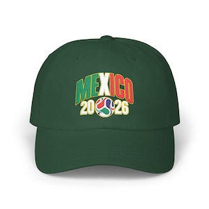 May include: A dark green baseball cap featuring an embroidered design on the front. The text MEXICO is arched in green, white, and red letters above the numbers 20 and 26, which flank a colorful, patterned soccer ball graphic in the center.