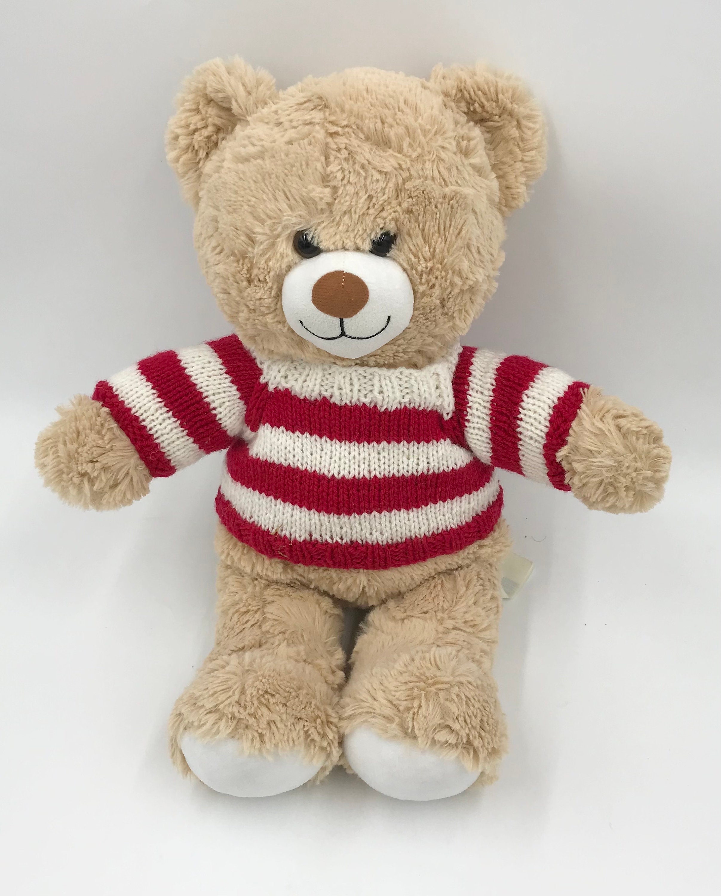 One of a kind brown teddy bear in a striped sweater