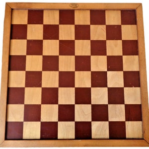 May include: A wooden chessboard with a brown and natural wood finish. The board has a traditional checkerboard pattern.