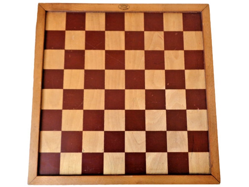 May include: A wooden chessboard with a brown and natural wood finish. The board has a traditional checkerboard pattern.