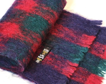 May include: A red, green, and purple fuzzy scarf with a black tag that reads "Natural Style World Over", with the words "Natural Style" in a larger font.
