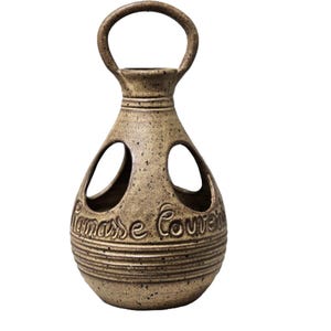 May include: A brown ceramic vase with a handle and cut-out designs. The vase has the words "Ramasse Couver" inscribed on the side.