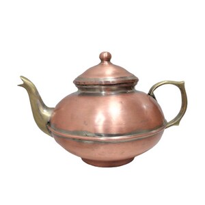 May include: A copper teapot with a brass spout and handle. The teapot has a round body and a domed lid.