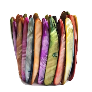 Op de afbeelding: Een kleurrijke armband gemaakt van iriserende schelpstukken. De armband is gemaakt van veel verschillende kleuren, waaronder roze, paars, groen, blauw en oranje.