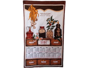 May include: A vintage kitchen towel with a 1987 calendar and illustrations of spices and herbs. The towel features the text "H. KROMBACH Hager" and "1987".