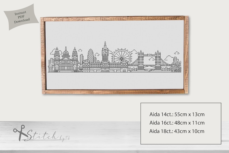 May include: Black and white line art illustration of the London skyline, including Big Ben, the London Eye, and Tower Bridge. The image is framed in a light brown wood frame. The text "Aida 14ct.: 55cm x 13cm, Aida 16ct.: 48cm x 11cm, Aida 18ct.: 43cm x 10cm" is printed below the image.
