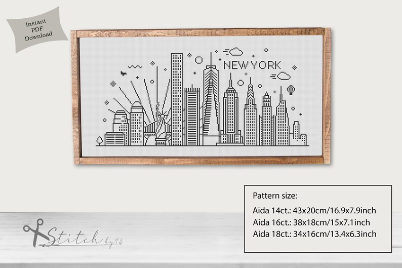 May include: Black and white cross-stitch pattern of the New York City skyline. The pattern includes the Empire State Building, the Chrysler Building, and the Statue of Liberty. The pattern is framed in a wooden frame. The pattern size is listed for Aida 14ct, 16ct, and 18ct.