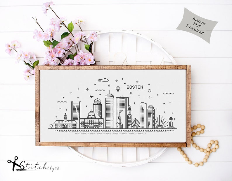 May include: A black and white line art illustration of the Boston skyline. The illustration includes the city's most iconic buildings, such as the State House and the Custom House Tower. The text "BOSTON" is written above the skyline.