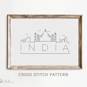 Puede incluir: Patrón de punto de cruz en blanco y negro del Taj Mahal con la palabra "INDIA" debajo. El patrón está enmarcado en un marco de madera claro.