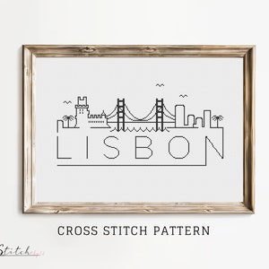 May include: Black and white cross stitch pattern of the Lisbon skyline, featuring a bridge, buildings, and the word "LISBON" in a simple font.