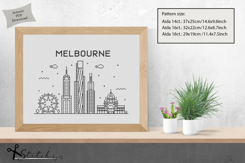 May include: A black and white line art illustration of the Melbourne skyline, including the Melbourne Star Observation Wheel, the Rialto Towers, and the Royal Exhibition Building. The image is framed and displayed on a shelf with potted plants.