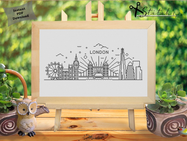 May include: Black and white line art illustration of the London skyline, including Big Ben, the London Eye, Tower Bridge, and the Shard. The text "LONDON" is above the skyline.