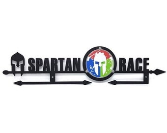 May include: Black metal Spartan Race sign with a Spartan helmet and the words "Spartan Race" in white lettering. The Spartan helmet is in a circle with a colorful splatter design.