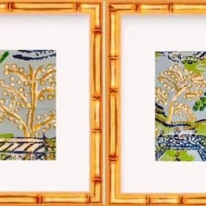 May include: Two framed prints with a blue and green floral pattern. The prints are in bamboo-style frames.